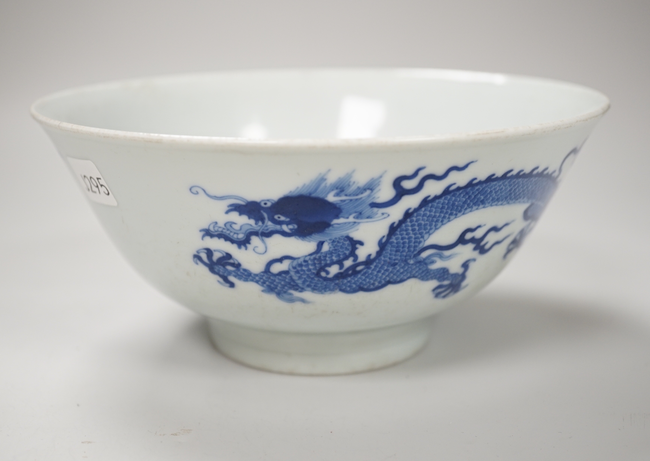 A Chinese blue and white bowl, hand painted with dragons, housed in a fitted case, 18cm in diameter